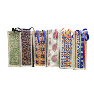 Set of six jute bags with colorful traditional prints and contrasting handles