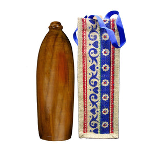 Handcrafted wooden bottle with decorative fabric bag featuring blue floral patterns and a blue strap