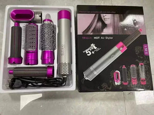 Hot air styling tool set with attachments and packaging on a tiled floor.