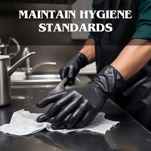 Person wearing black gloves wiping stainless steel kitchen surface with cloth, maintaining hygiene standards