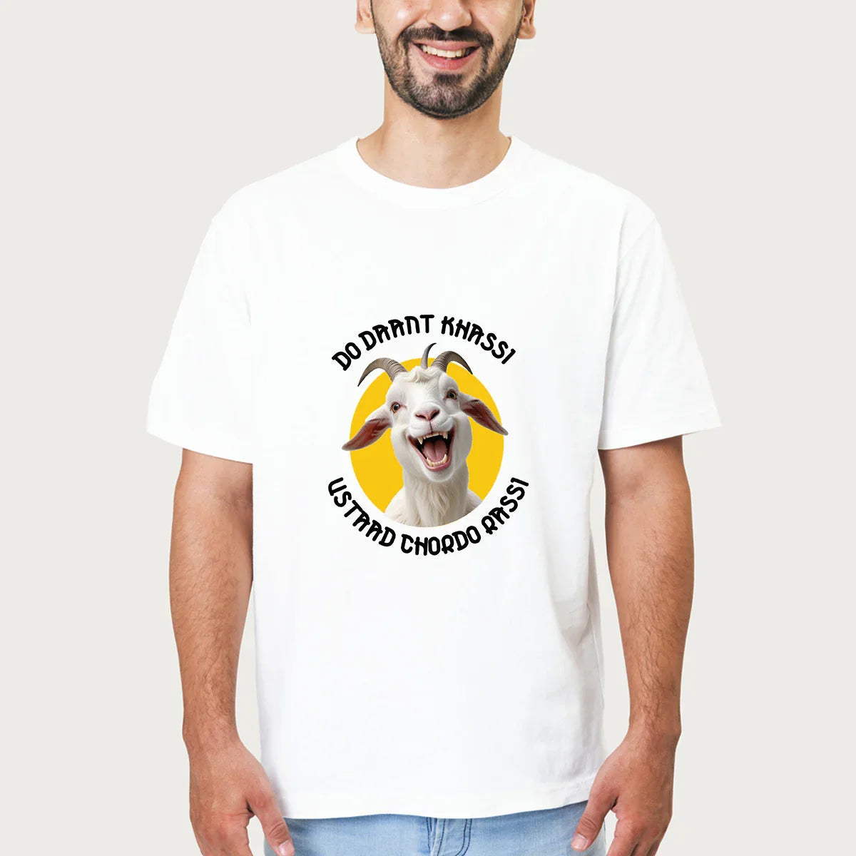 Man wearing white t-shirt with a laughing goat graphic and text in black on yellow background
