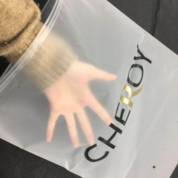 Hand inside transparent zip lock bag with CHEROY branding in black and gold letters